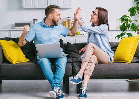 An excited couple on a couch